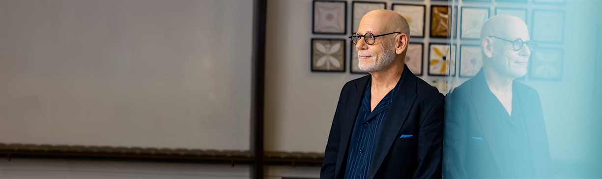 Dr. Cohen leaning on wall