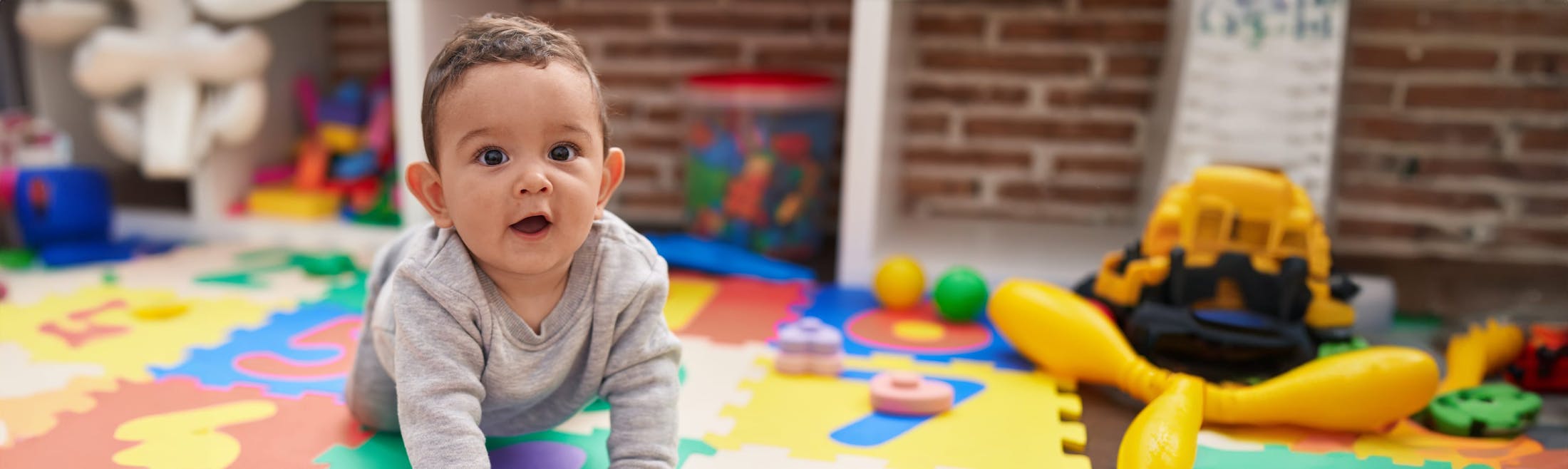 child playing on colored mat