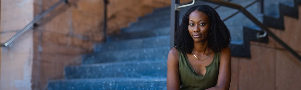 woman sitting near stairwell