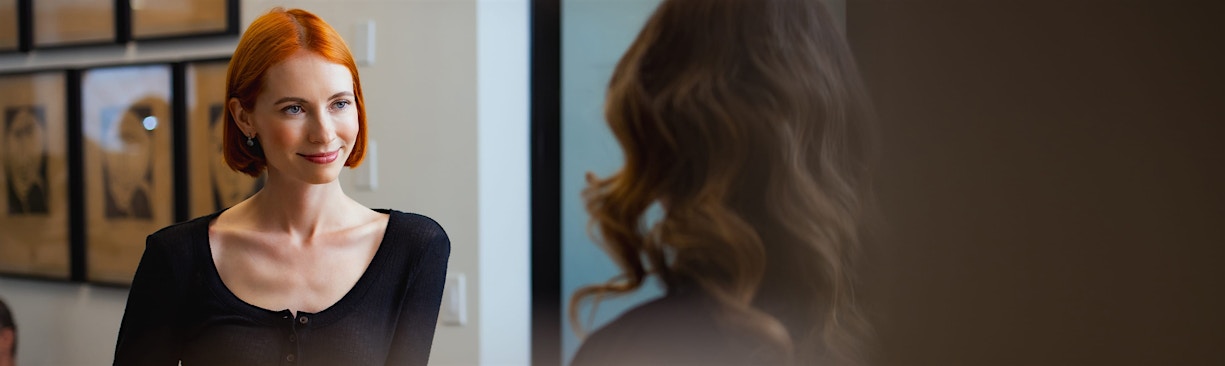 woman speaking to front desk