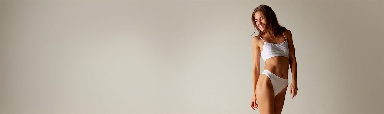 woman posing in white undergarments