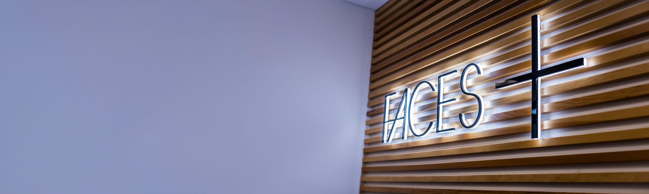 Faces+ lit sign