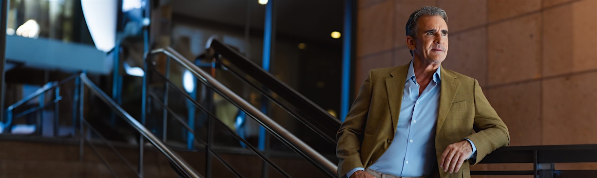 man in suit resting on stairwell