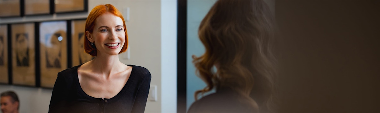 woman speaking with front desk