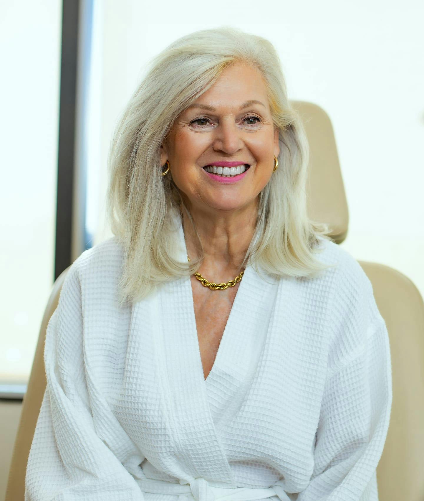 woman in bathrobe smiling