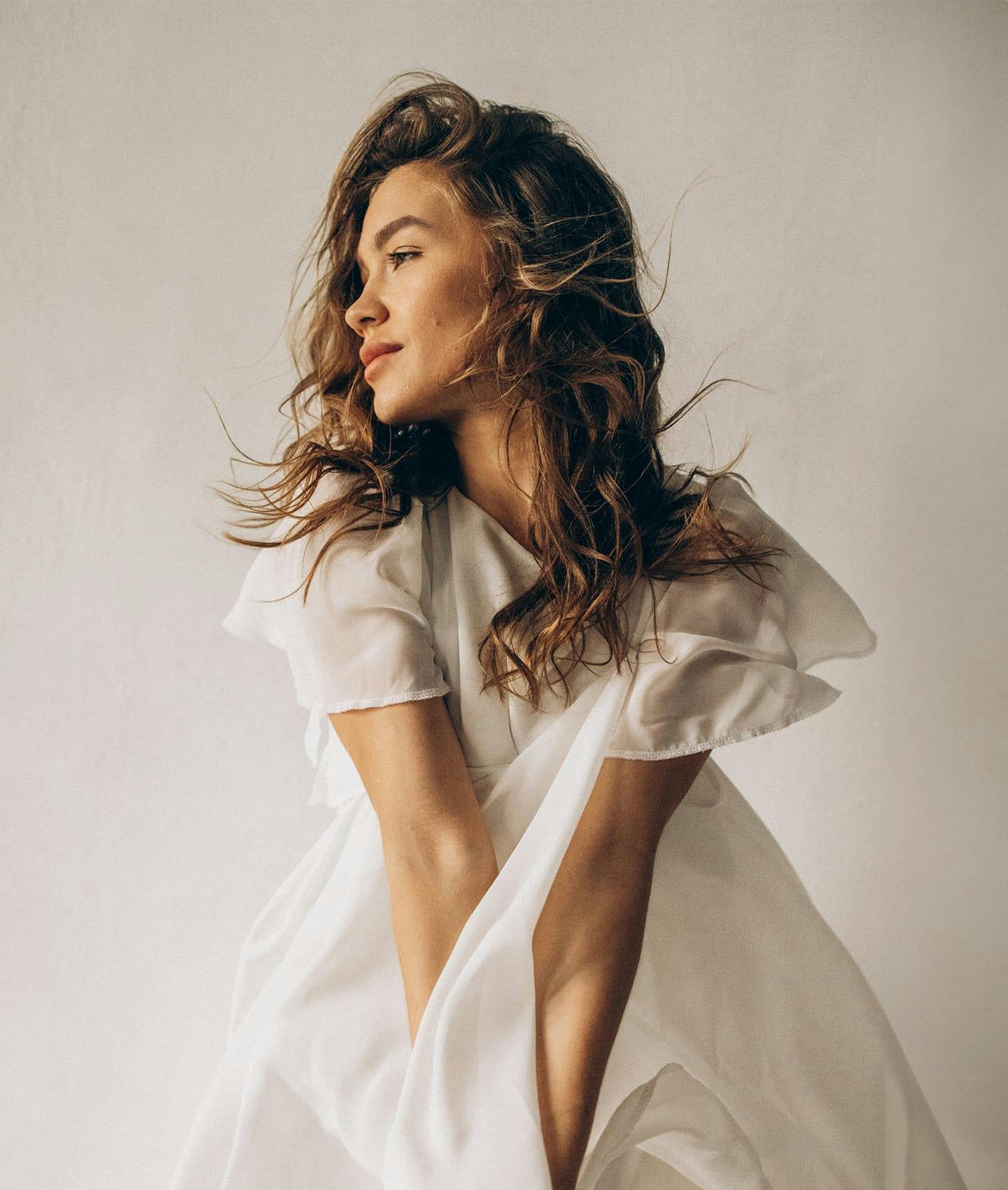 woman posing in white dress