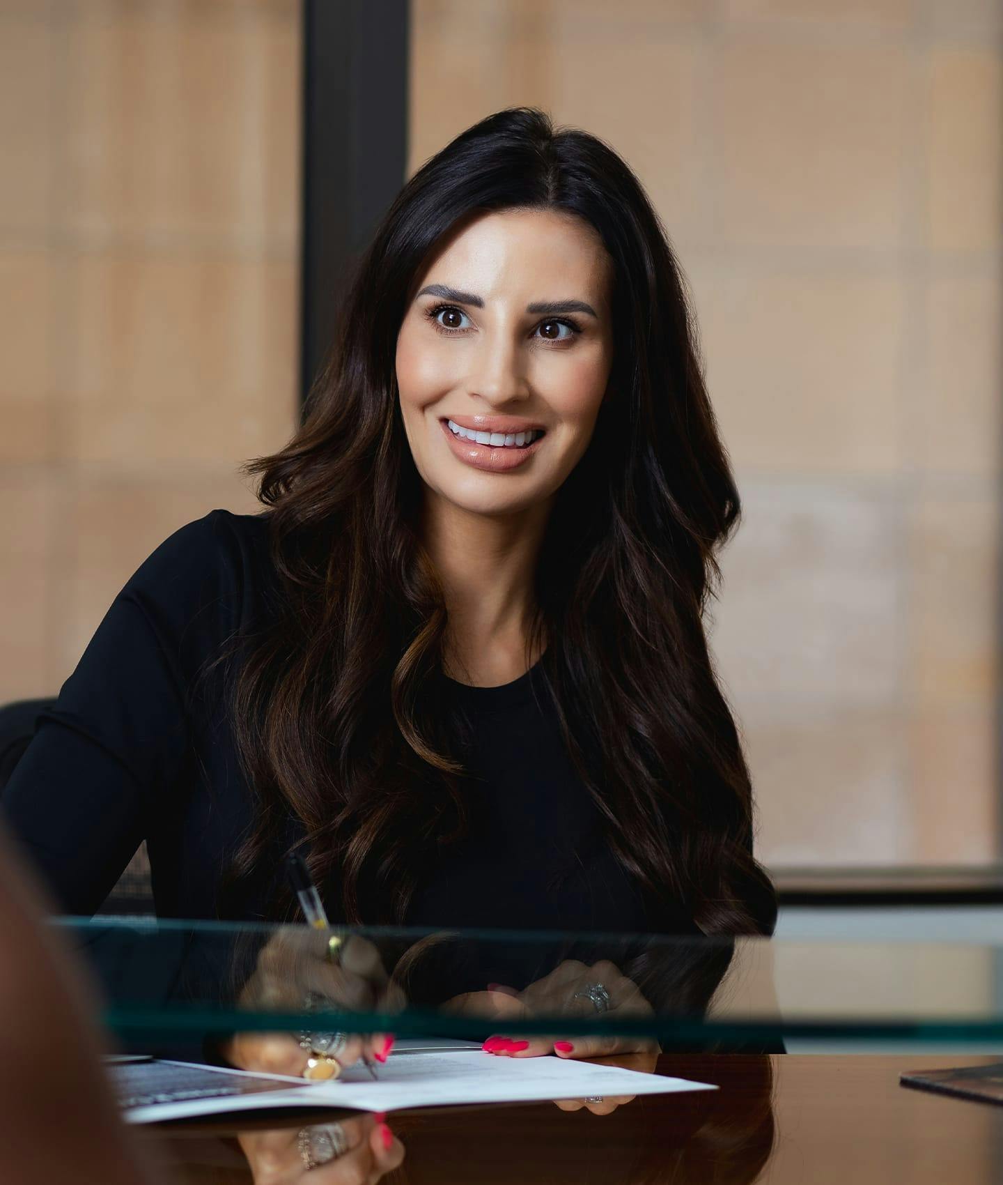 woman signing document and smiling