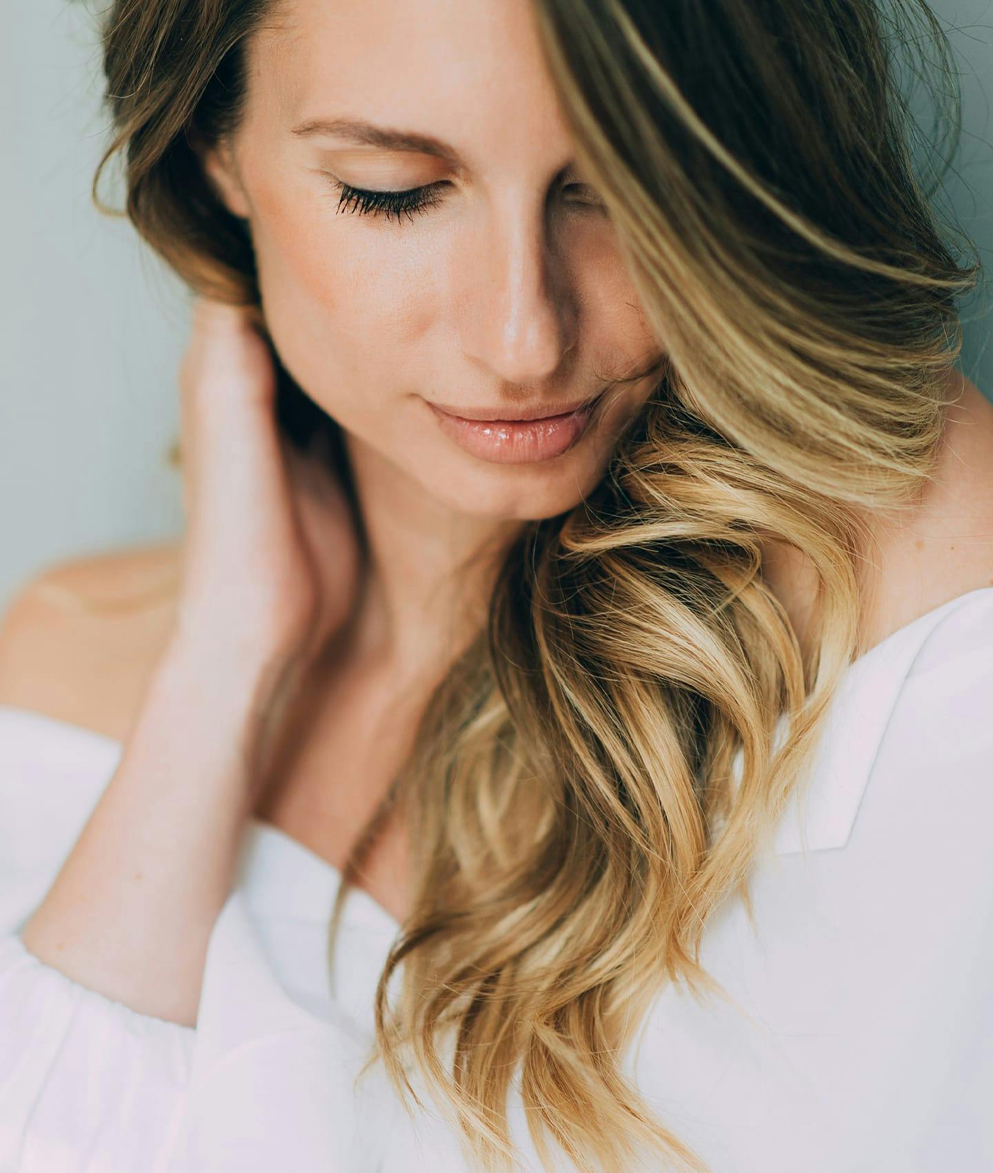 woman resting hand on neck