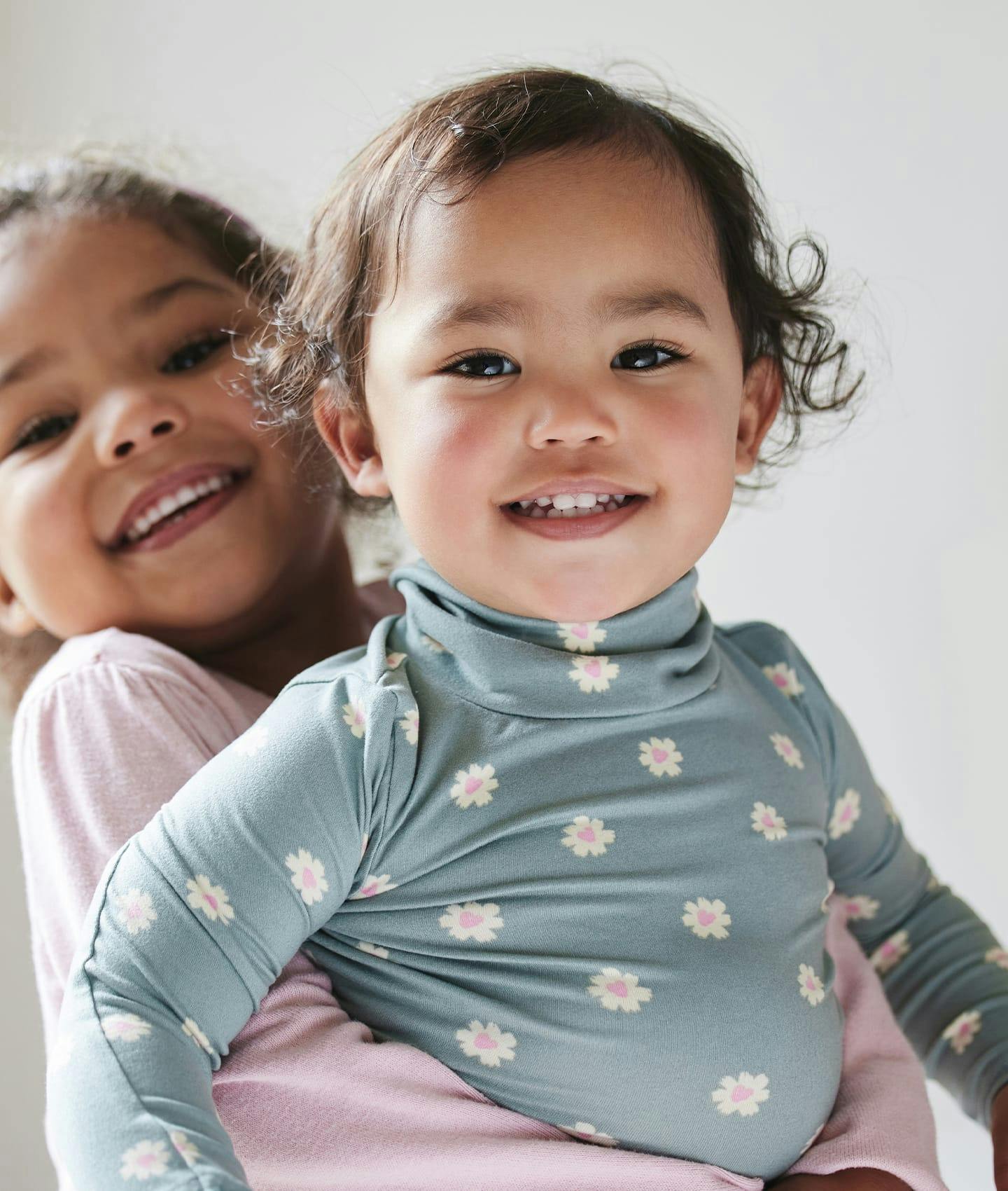 young child being held by little girl