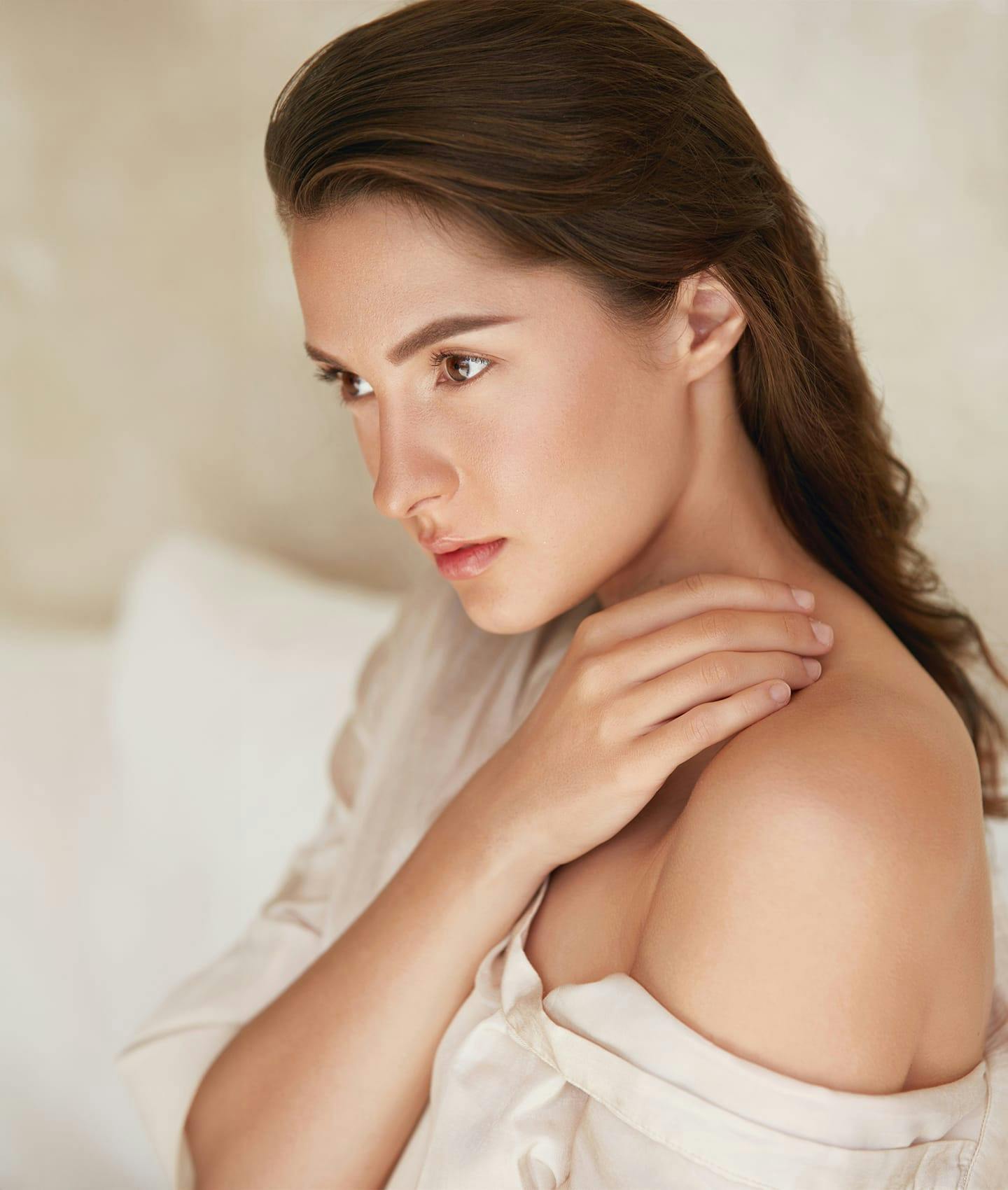 woman resting hand on her shoulder