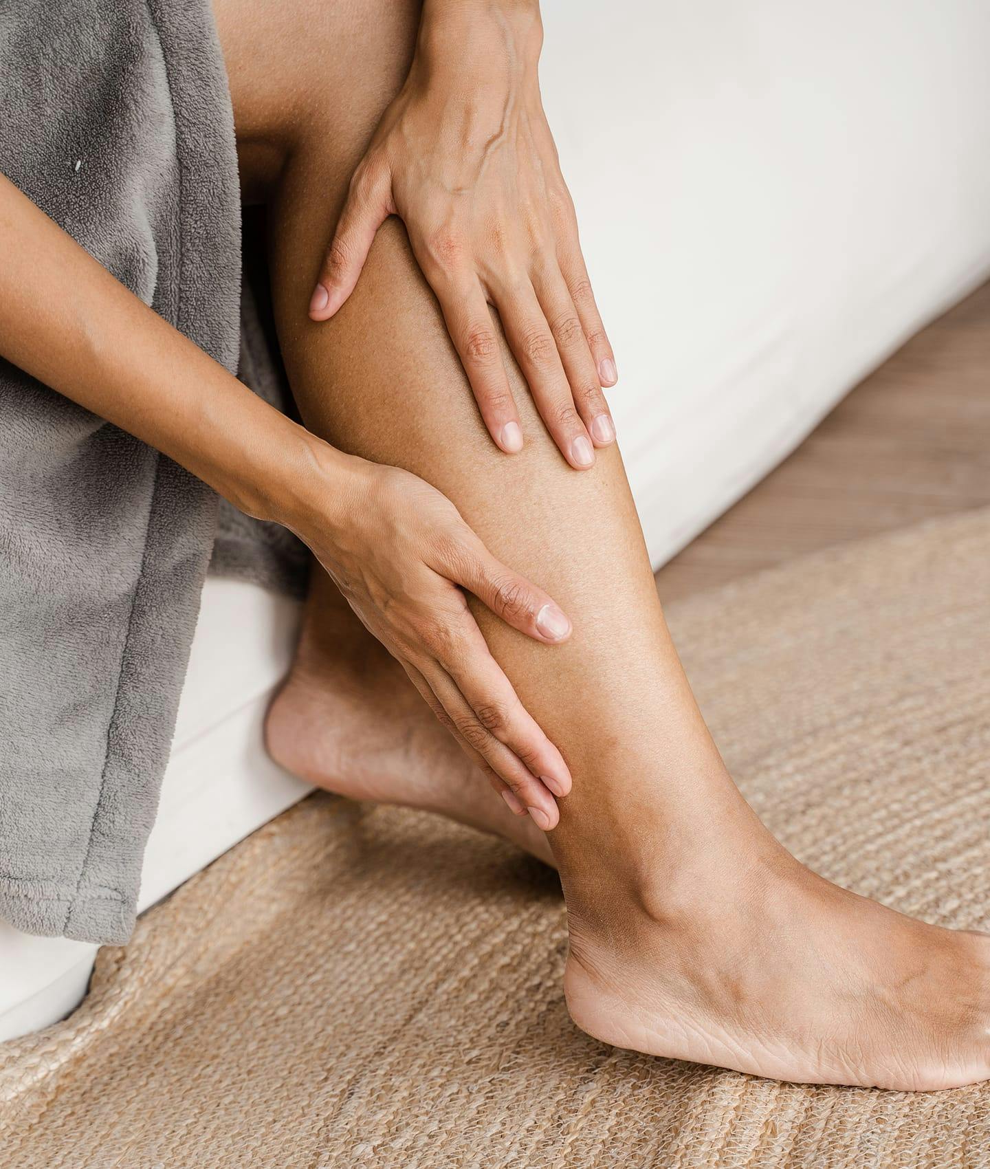 woman feeling her legs