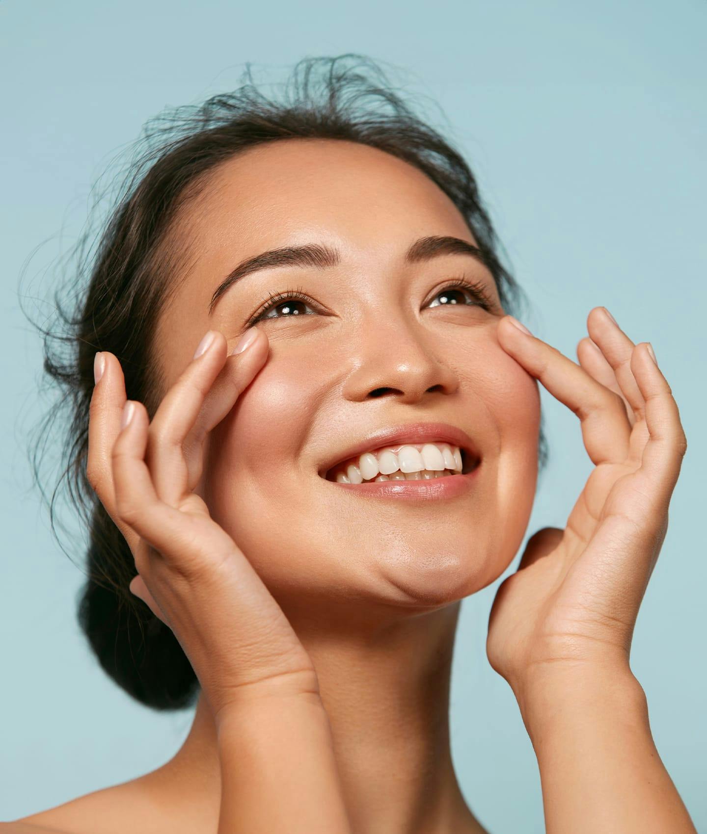 woman brushing fingers over cheeks