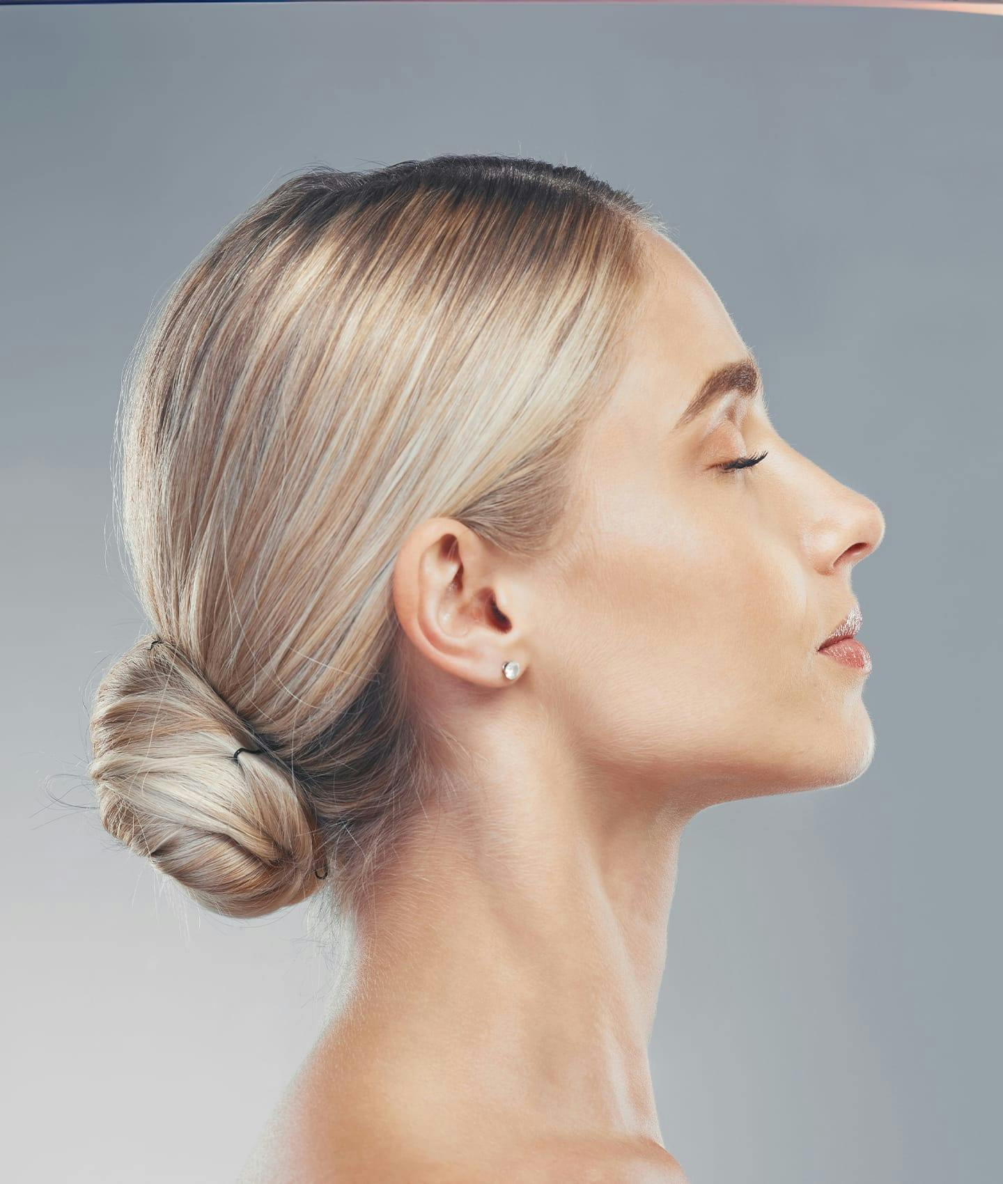 blonde woman with hair in bun