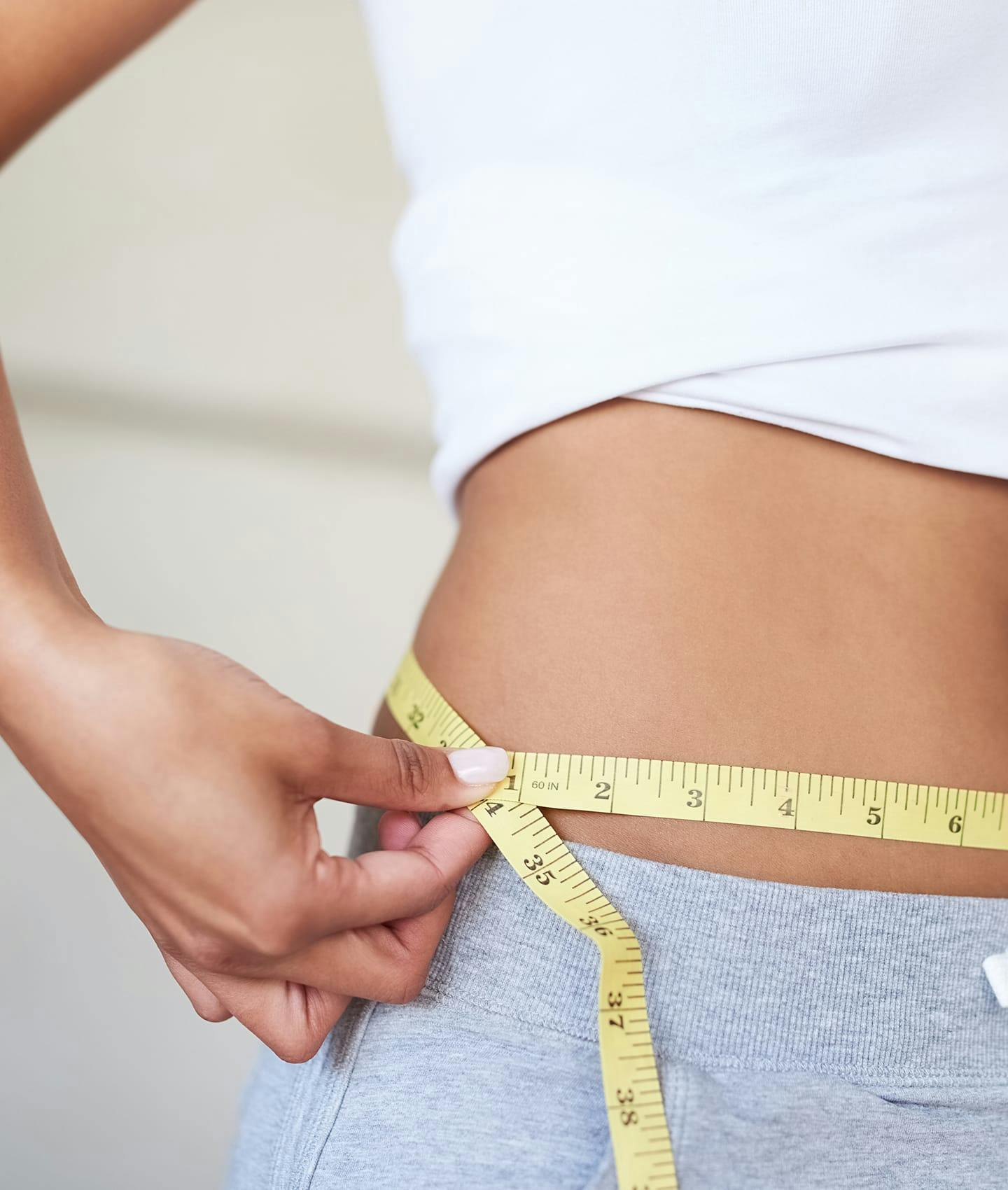 woman measuring waist