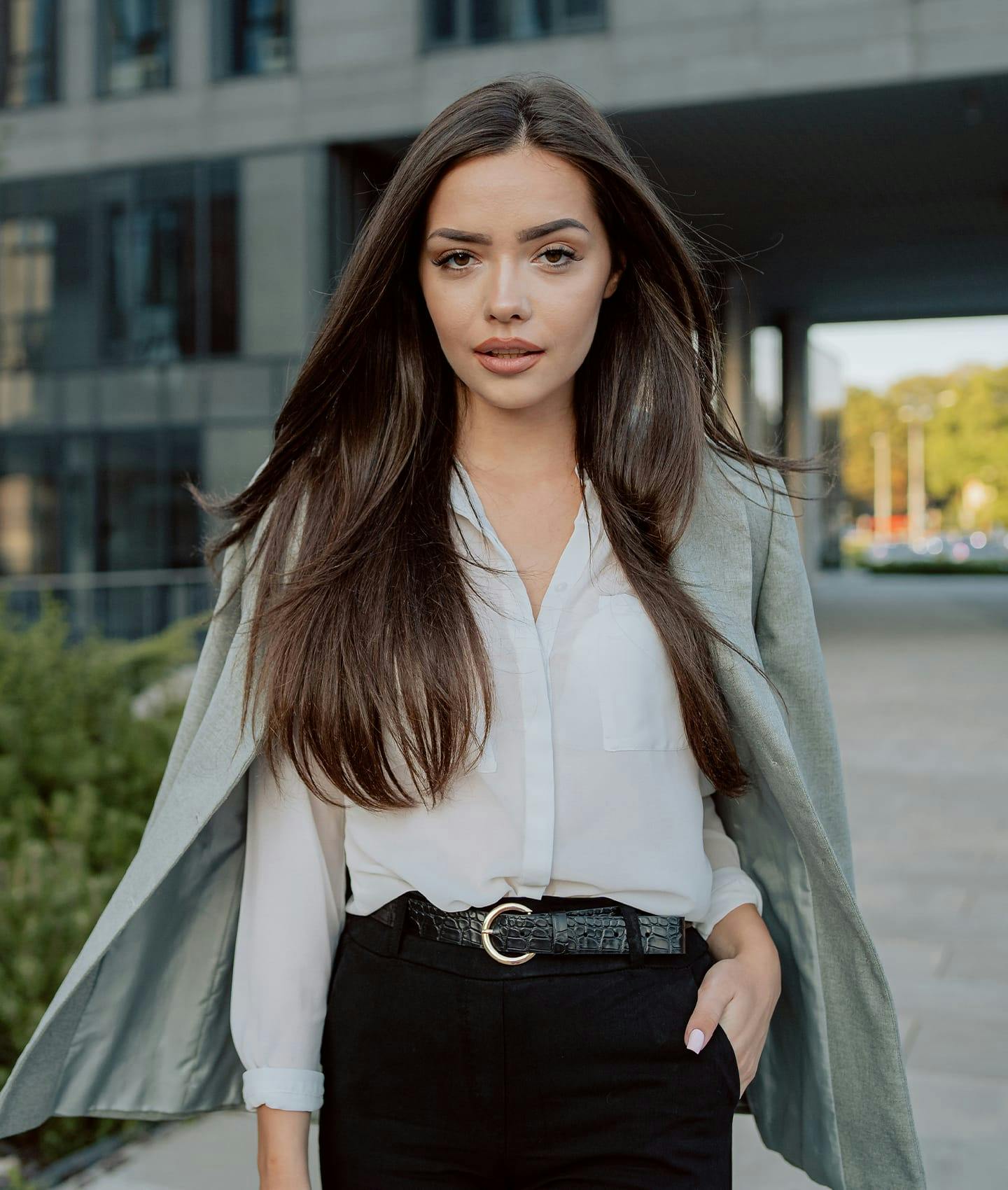 woman in white blouse and overcoat