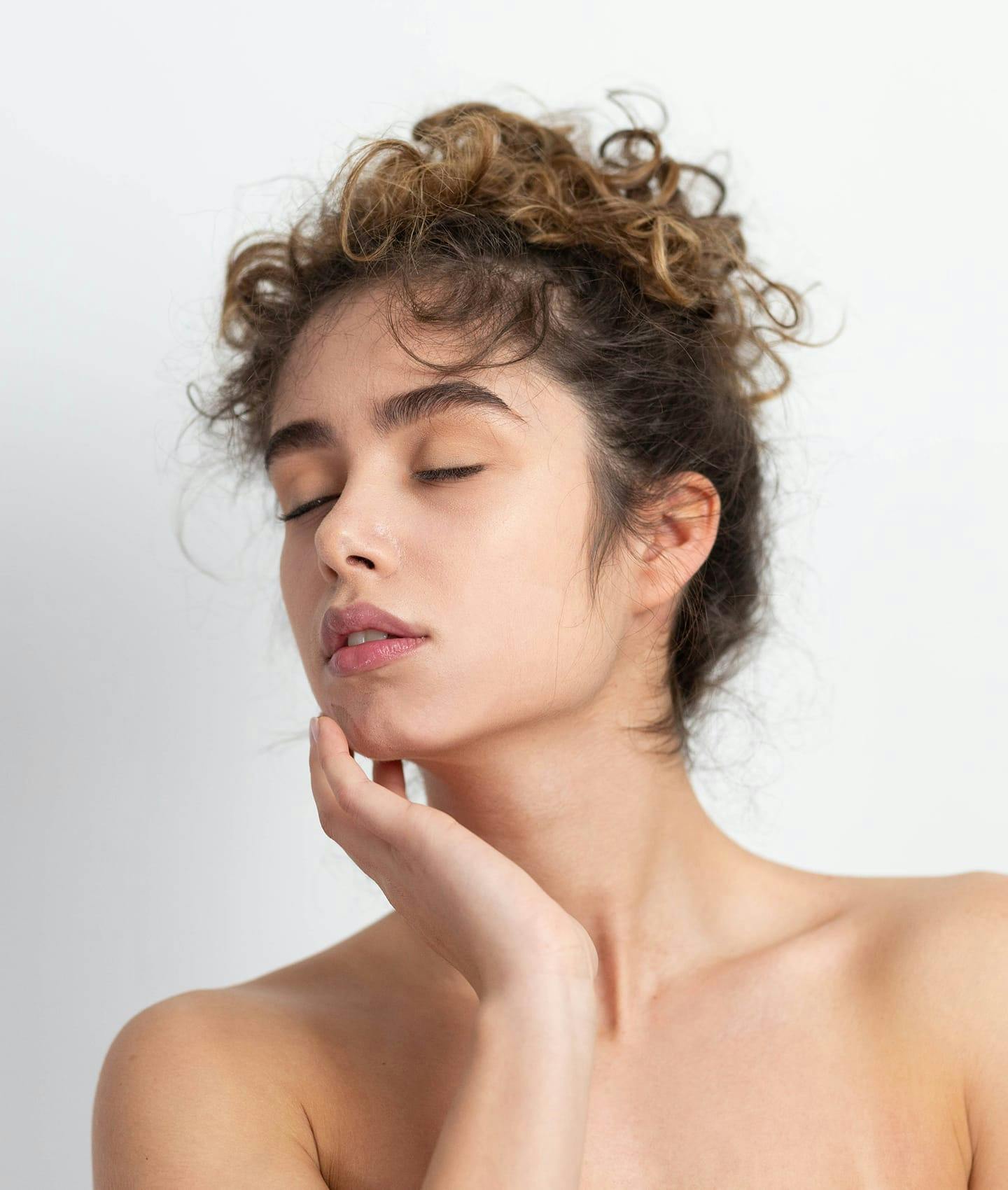 woman posing with hand on face