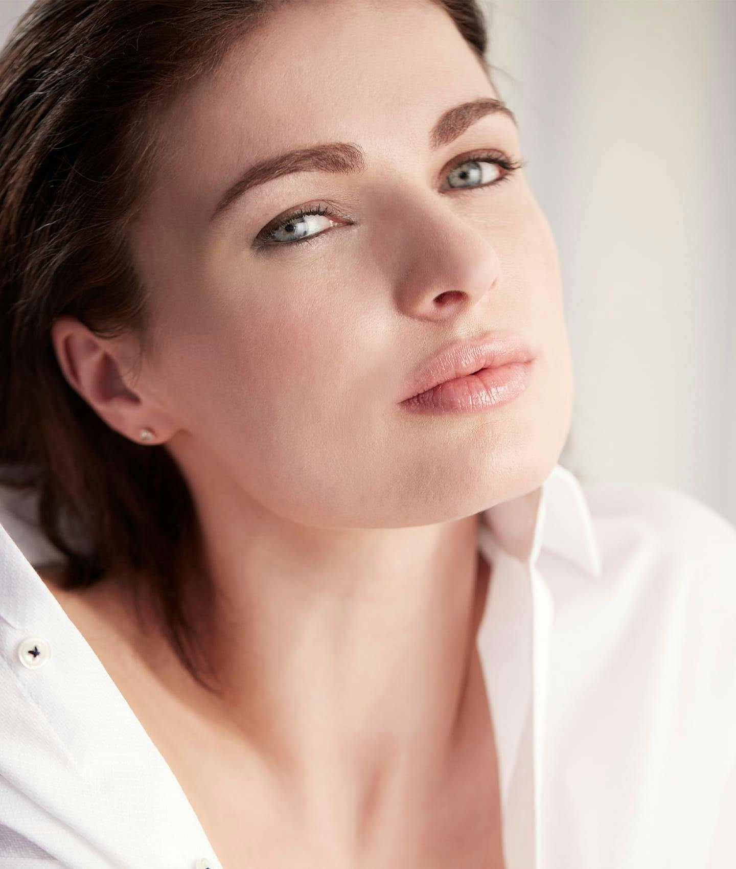 woman in white blouse smiling