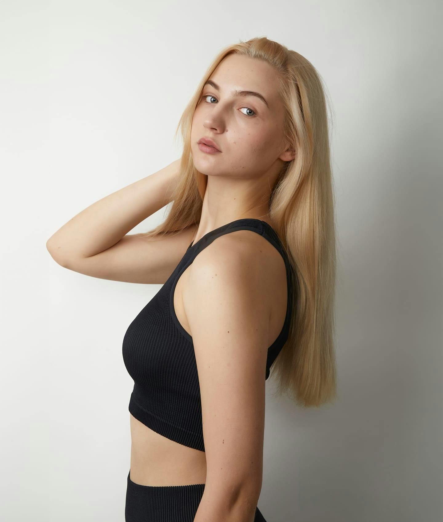 woman in black underwear looking over her shoulder