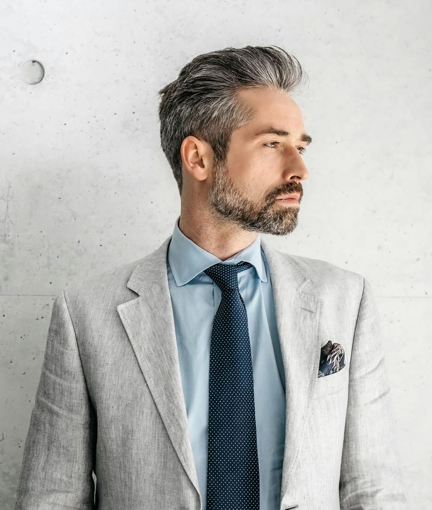 man in suit looking over shoulder