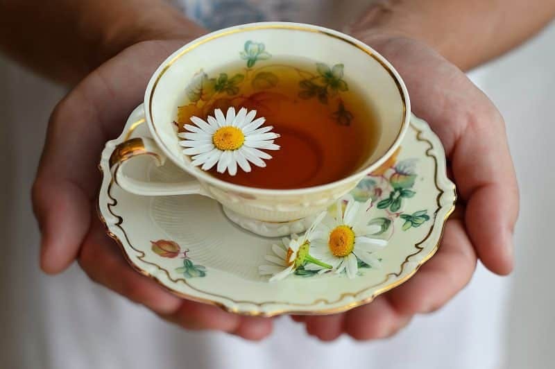 A woman holding a cup of tea