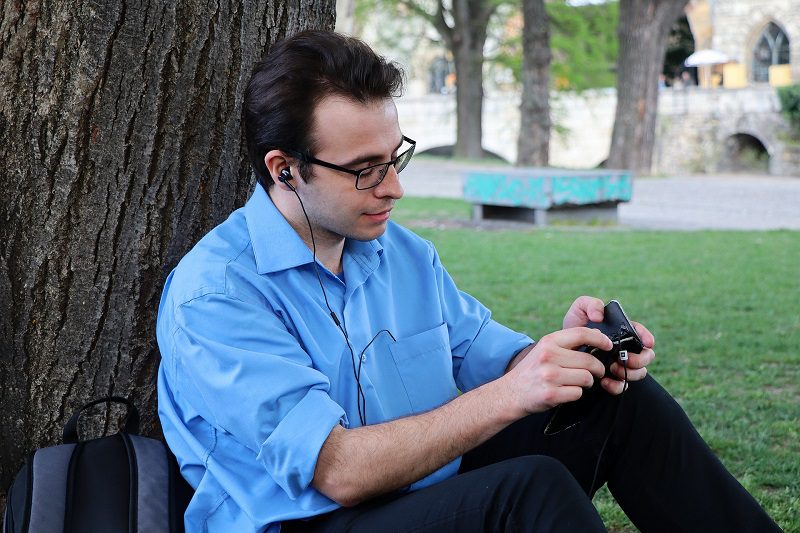 Dr. Allan Wulc PRP Injections Review Man Sitting Under a Tree Listening to Music