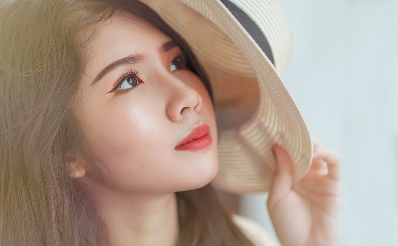 What are Peptides Woman Wearing a Hat Looking Off to the Side