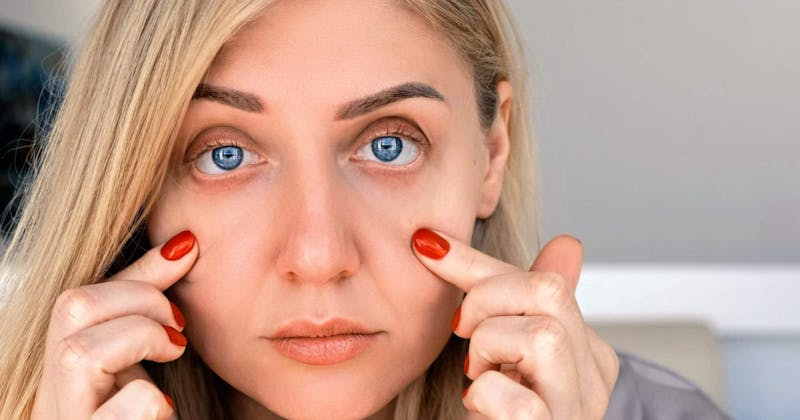 Woman touching her undereyes