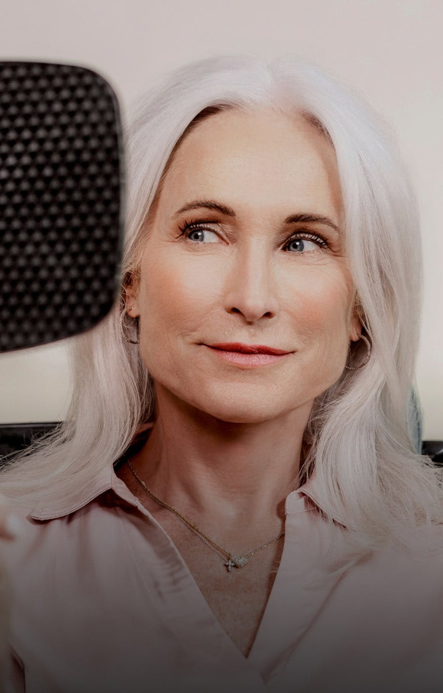 older woman looking in a handheld mirror