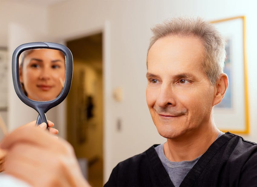 doctor and patient looking into mirror