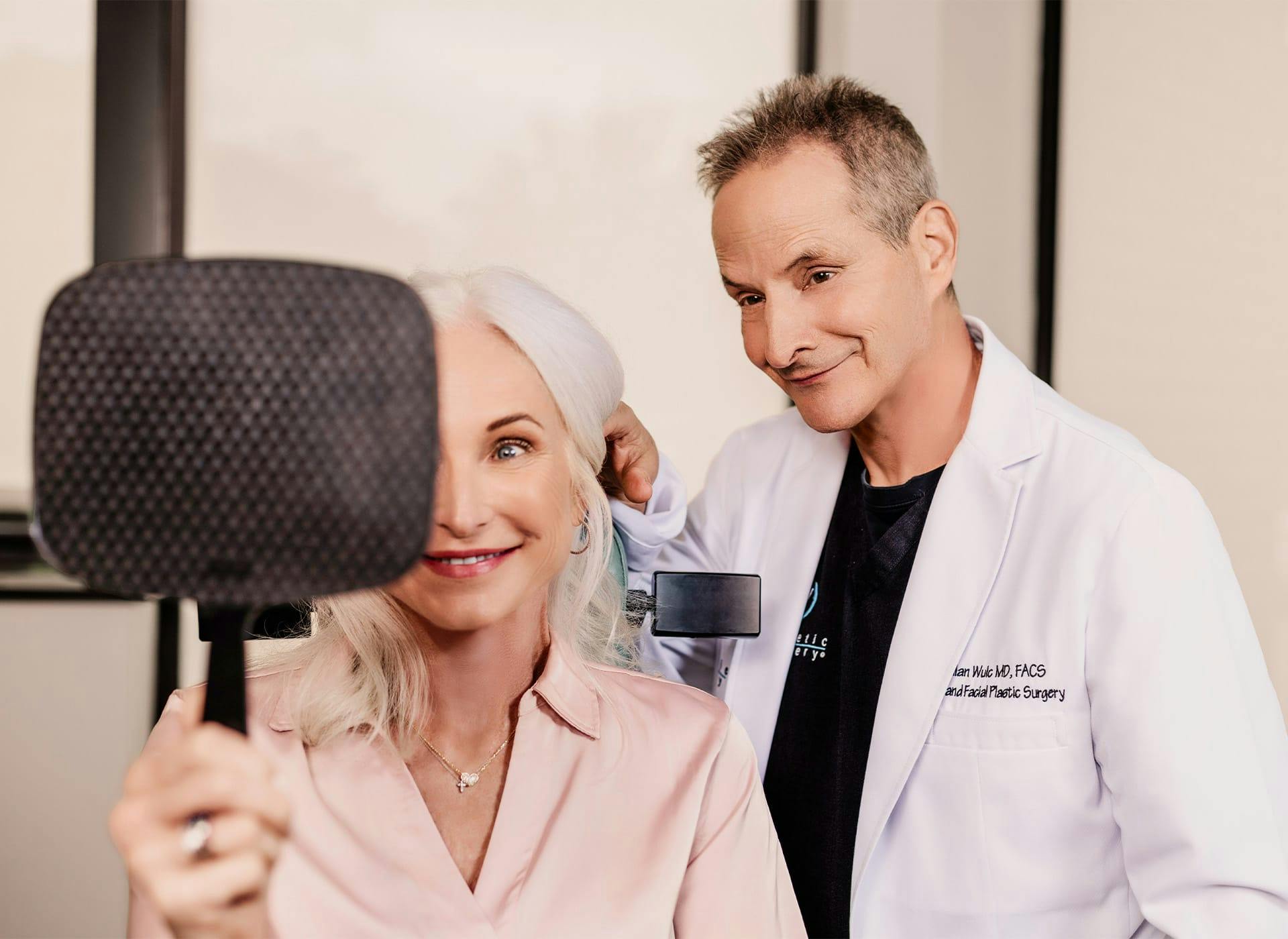 Doctor and patient looking into mirror