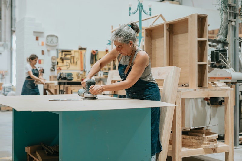 Woman working on a piece of wood