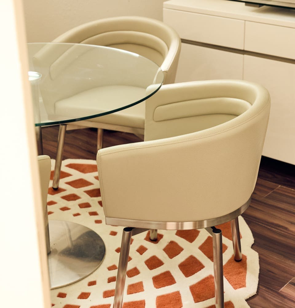2 chairs on orange patterned rug