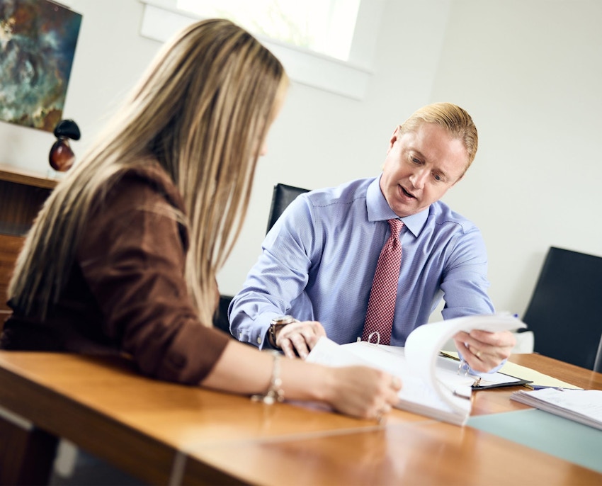Tyler holding paper up for client