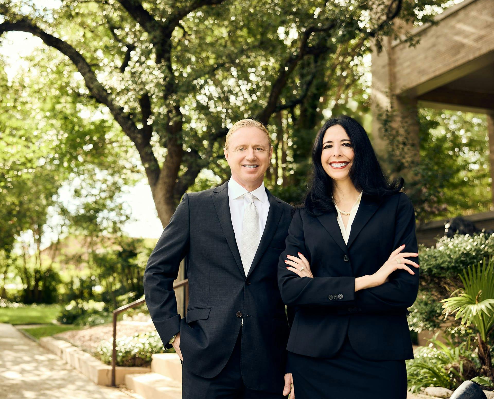 Tyler and Hella in suits smiling