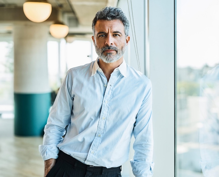 man leaning against big window