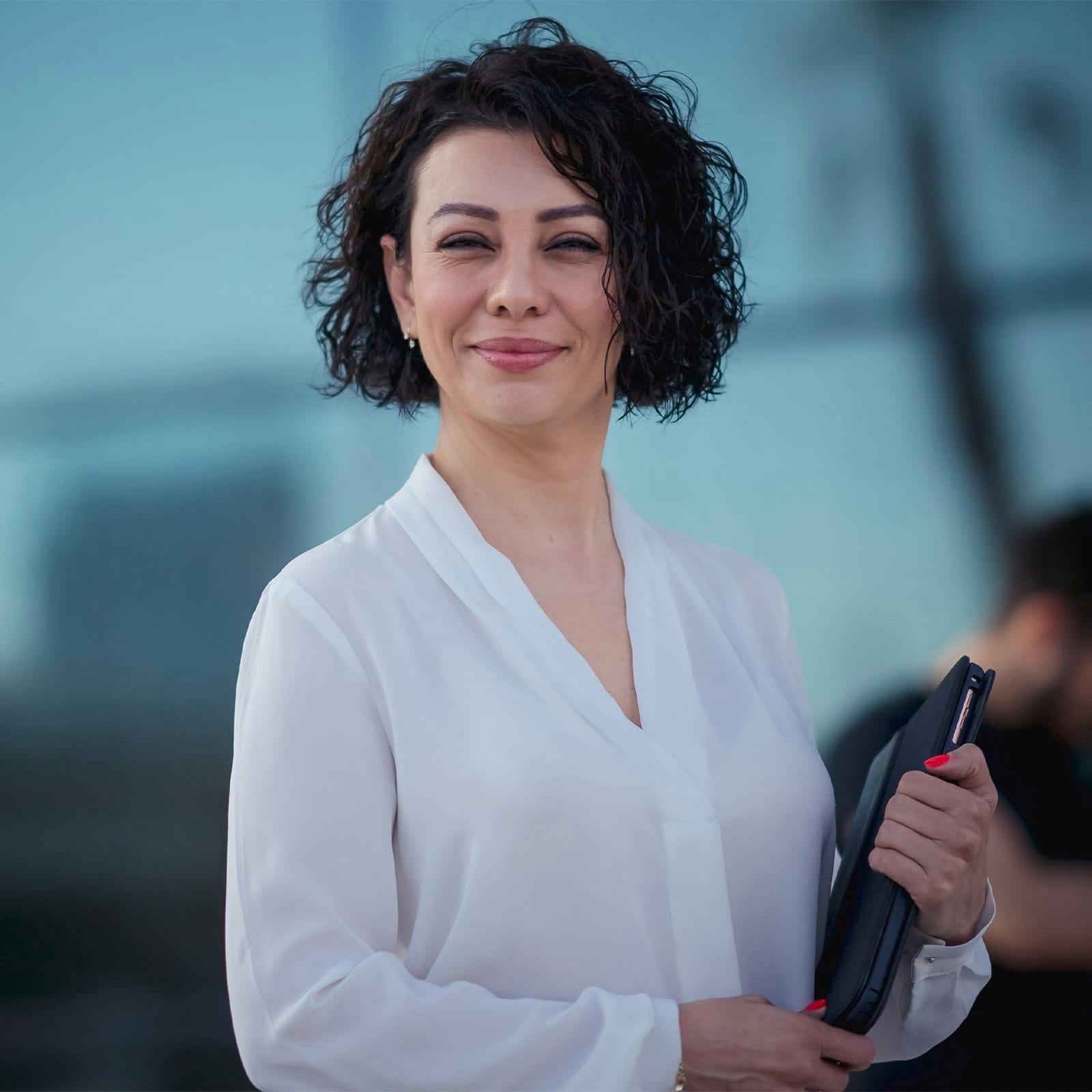 woman with short hair holding an ipad