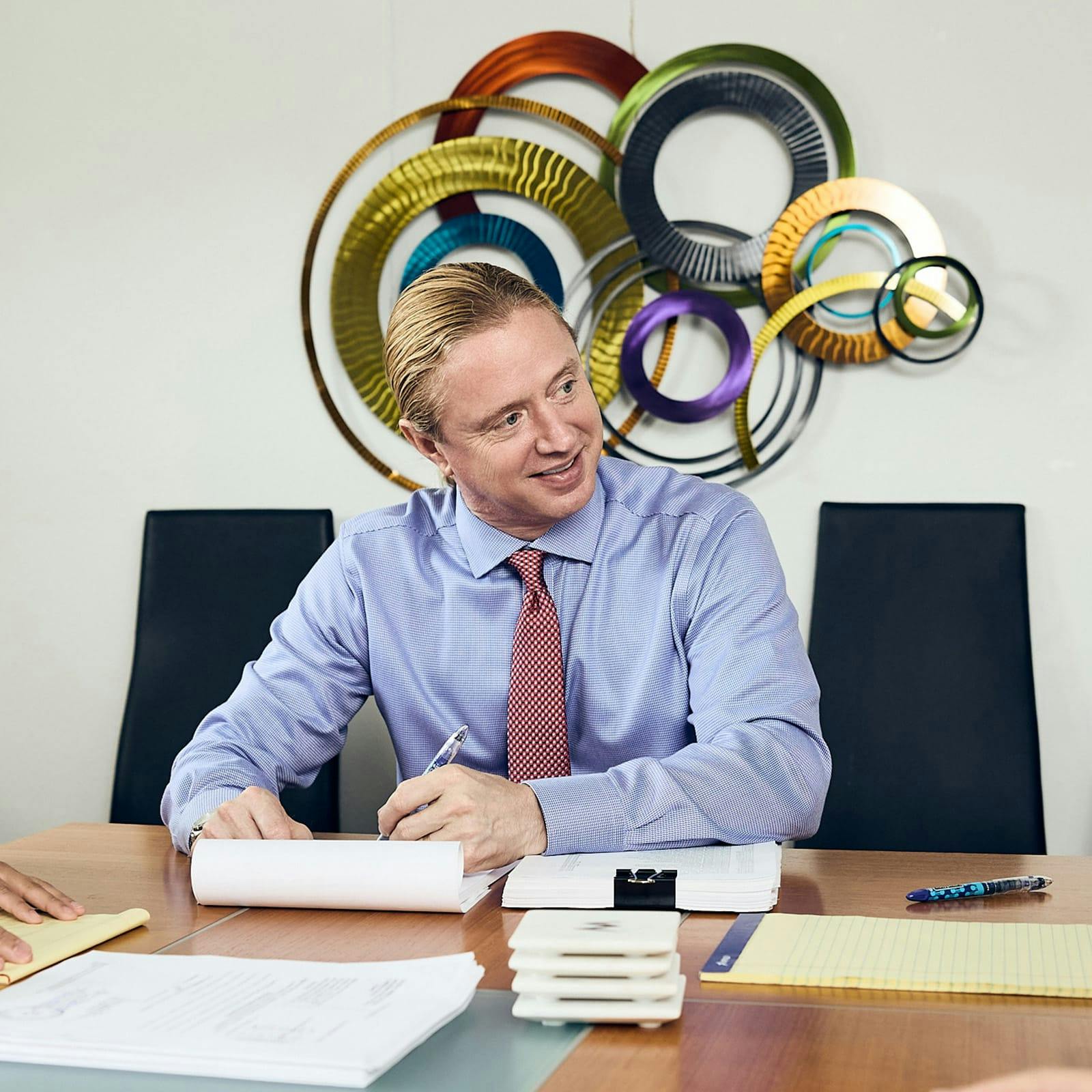 Tyler sitting at table about to do paperwork