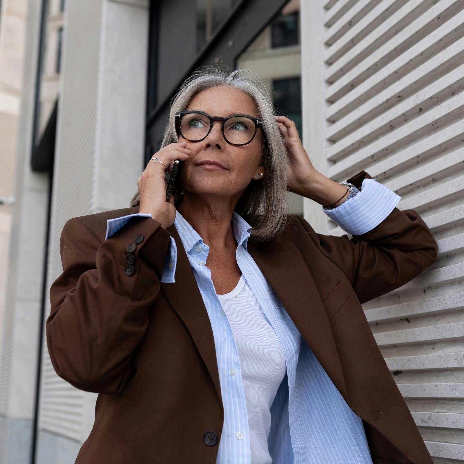 older woman with glasses on the phone