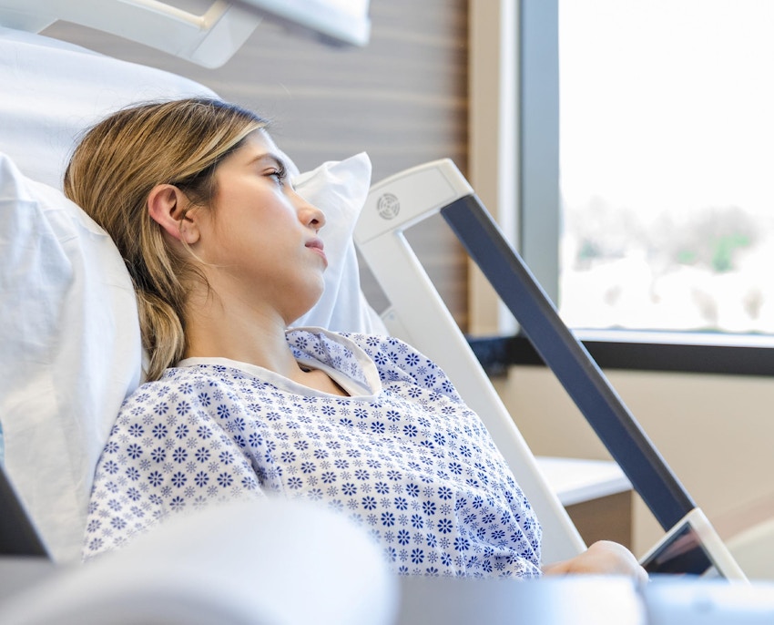 Hella standing up with her hand on Tyler's back while hes sits
