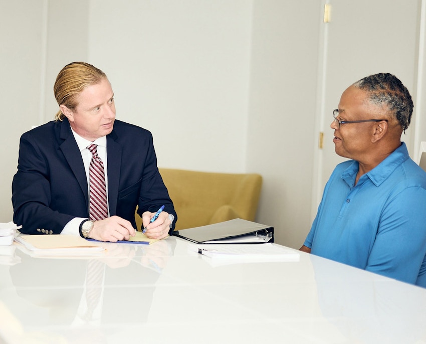 Tyler sitting and speaking to client
