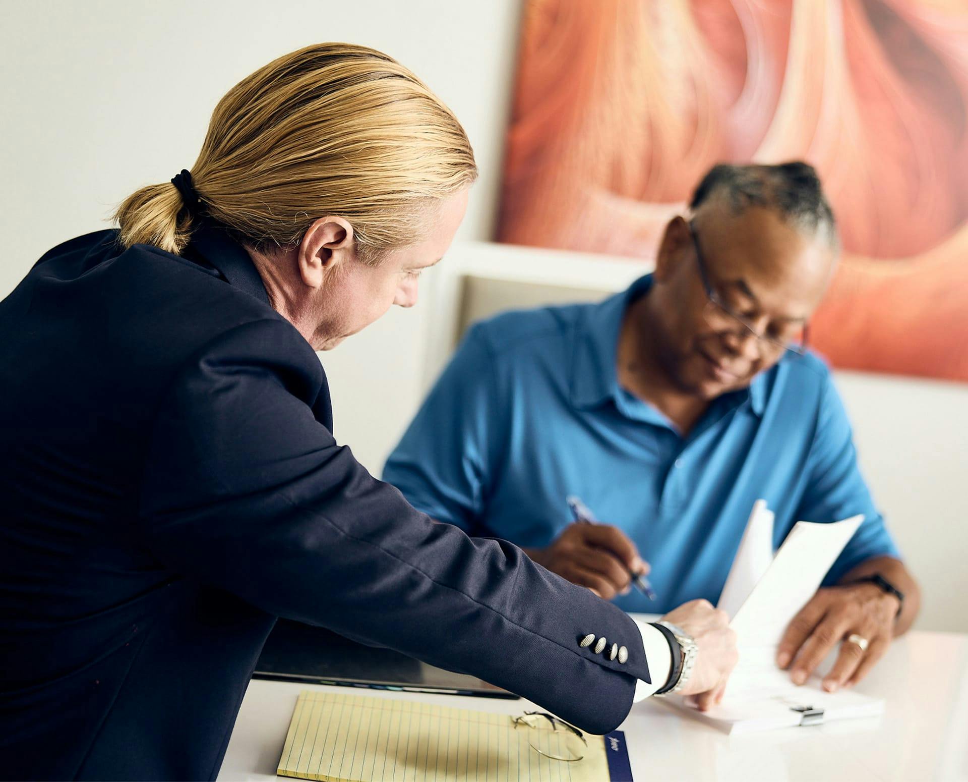 Tyler holding paperwork for client to sign