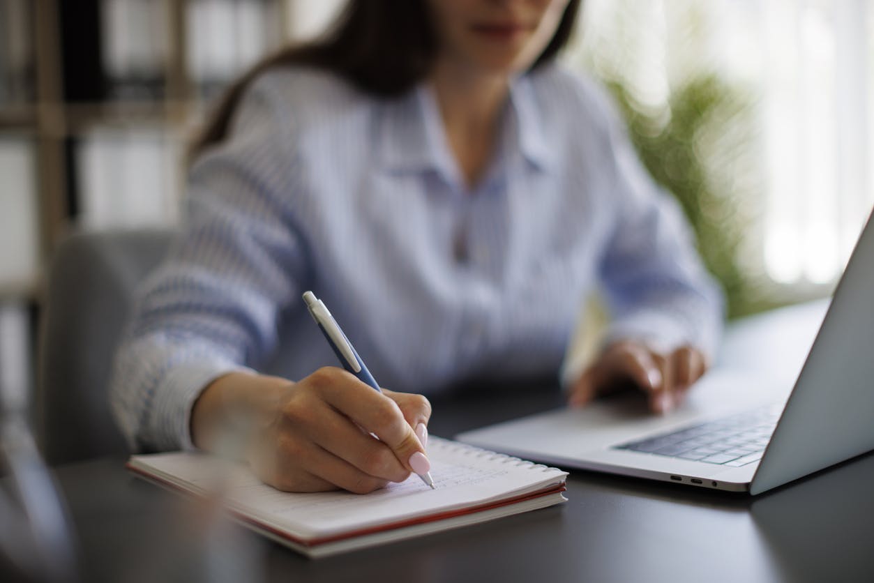 A woman writing on notepad
