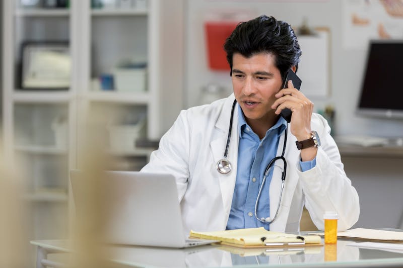 A doctor talking on phone