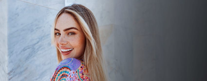 Woman smiling over shoulder