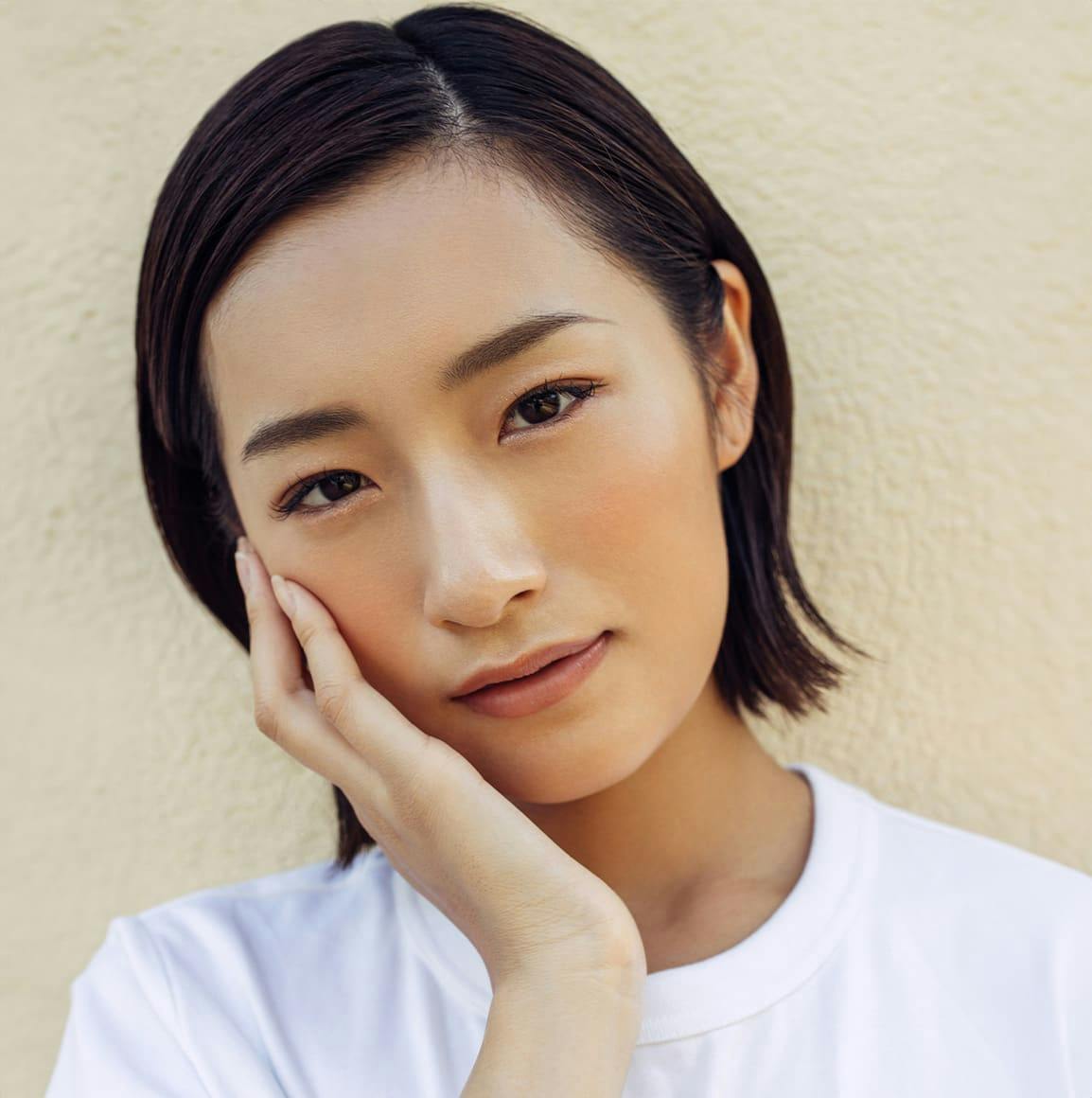 Woman with hand on face