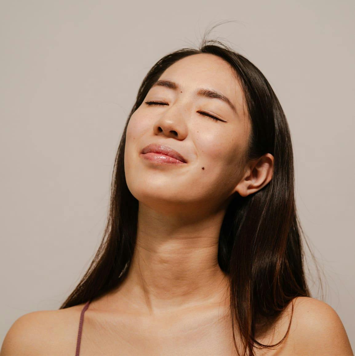 Woman smiling with eyes closed