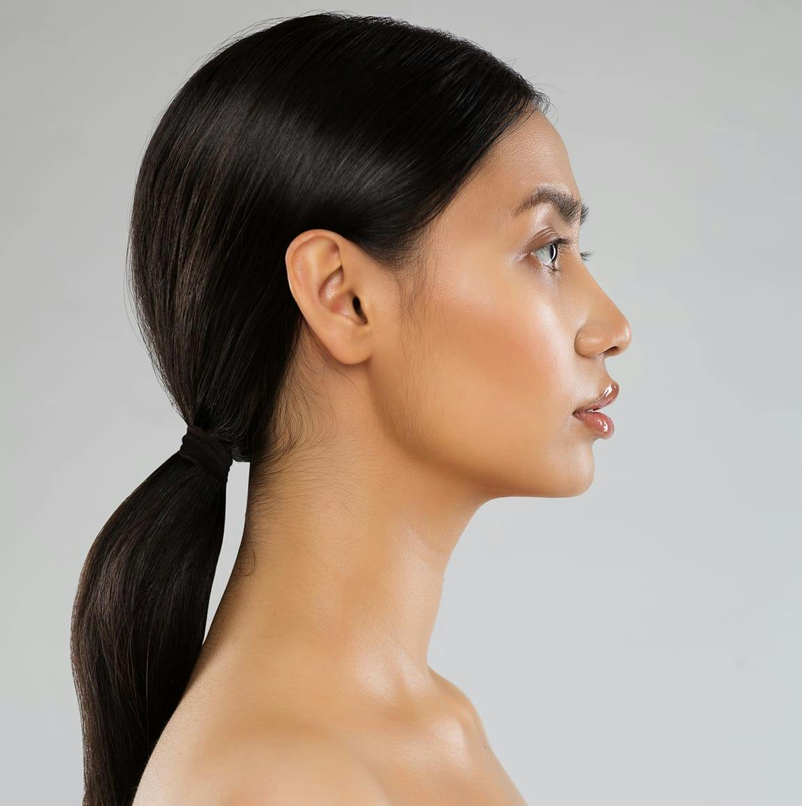 side profile of woman with dark hair in a ponytail