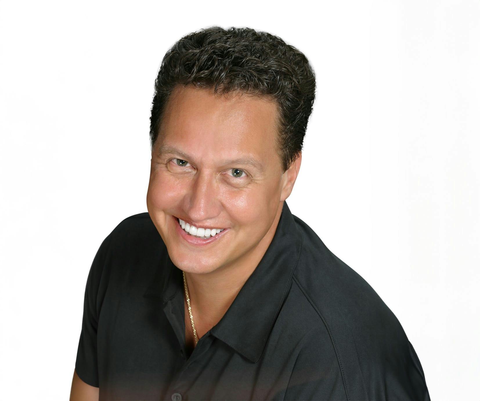 man in a black shirt smiling