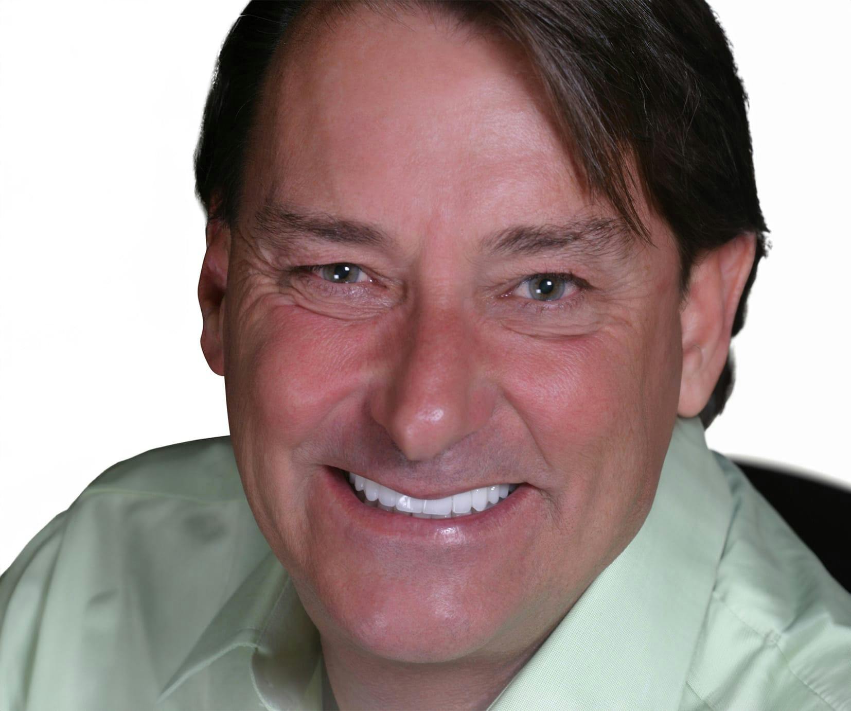 man in a green shirt smiling