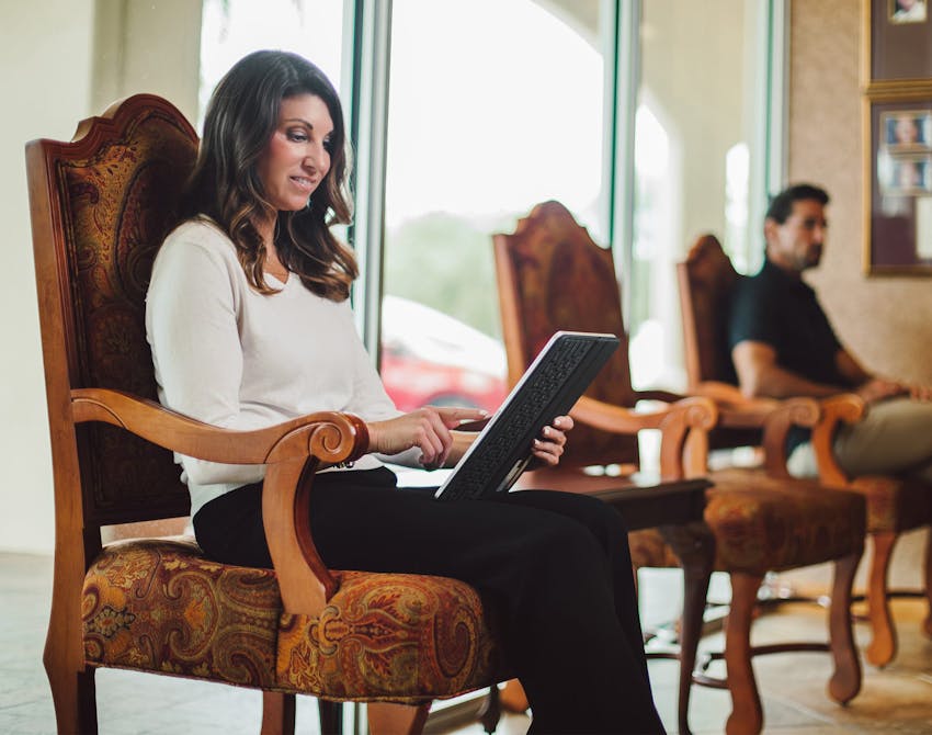 woman filling out documents in a waiting room